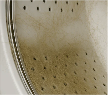 Washing machine drum clogged with dog and pet hair before cleaning